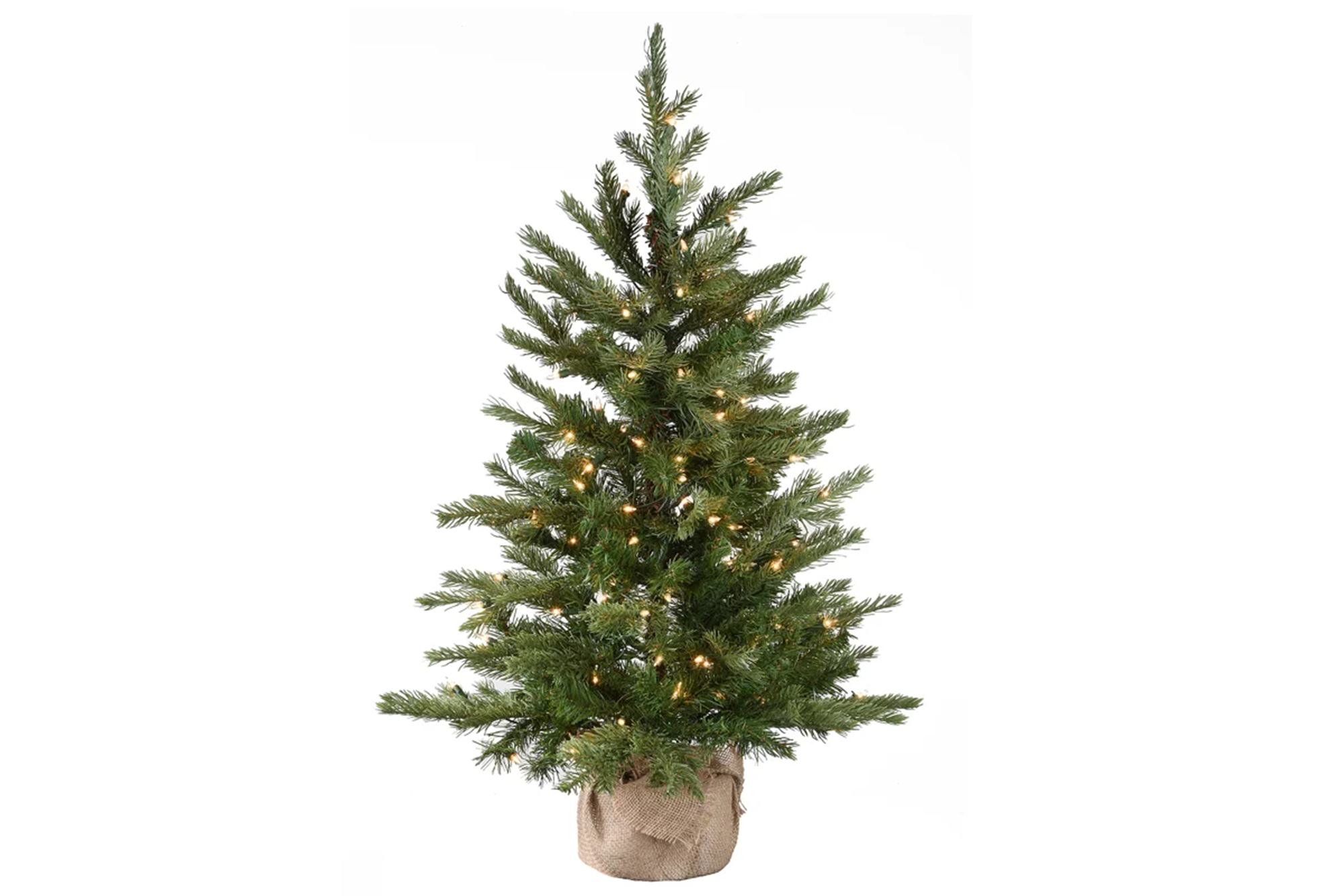 A pre-lit tabletop Christmas tree on a burlap base against a white background.